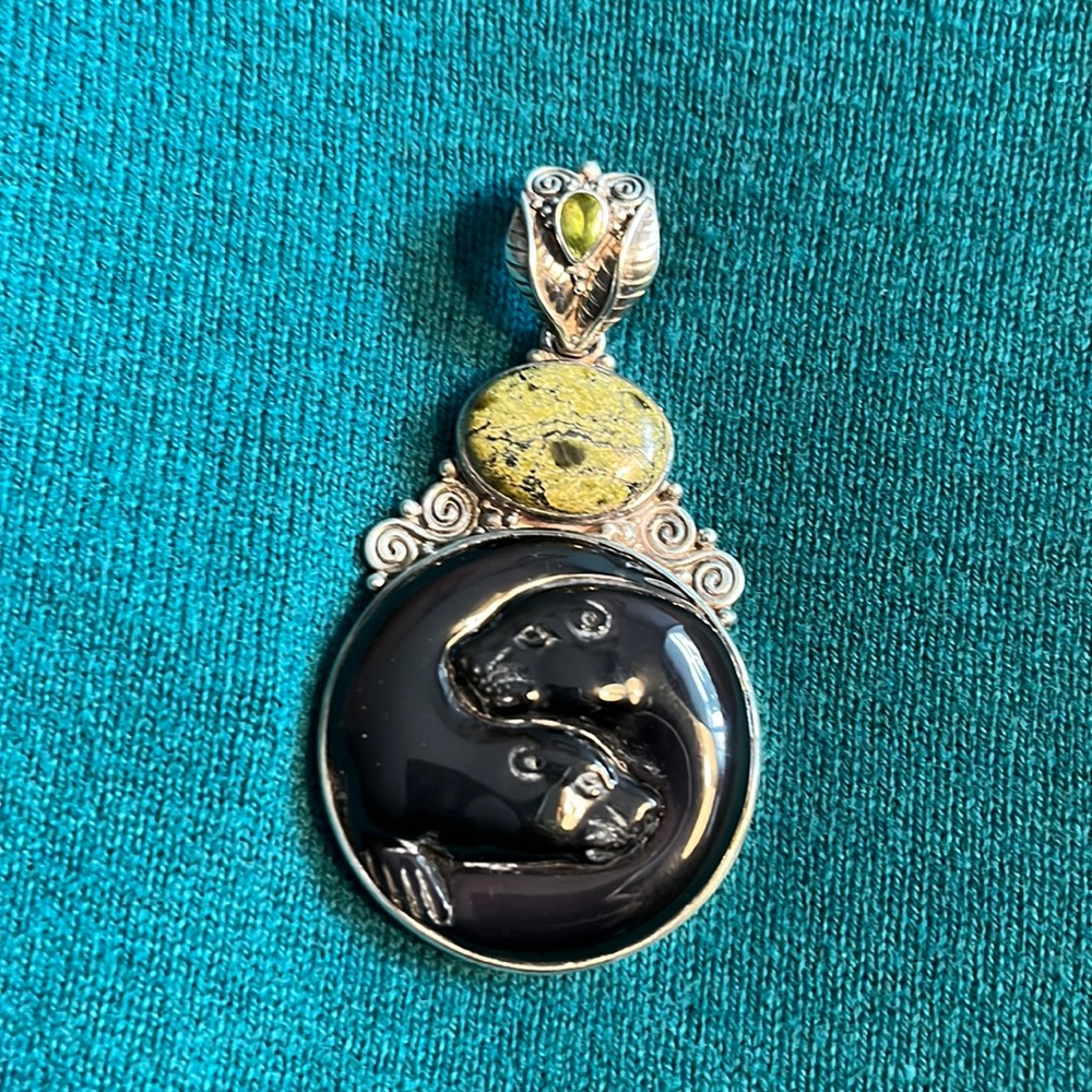 Silver pendant with two seals carved in black stone with carved silver bale